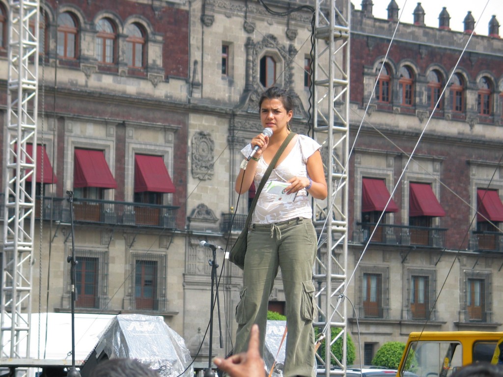  woman announcing the how one can sign up as a delegate for a national conference on democracy, September 16th