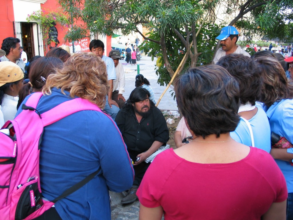 Flavio Sosa and a group of female teachers chatting casually.